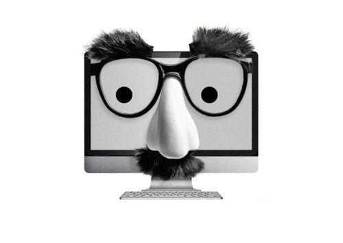 A computer monitor wearing a Groucho Marx-style disguise with glasses, a fake nose, eyebrows, and mustache