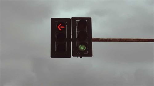 A traffic light showing a red left-turn arrow and a green light